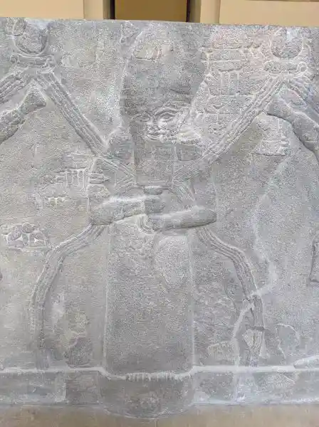 Detail of the reconstruction of Ashur water basin, a water deity bearing overflowing vessel, located in Pergamon museum.